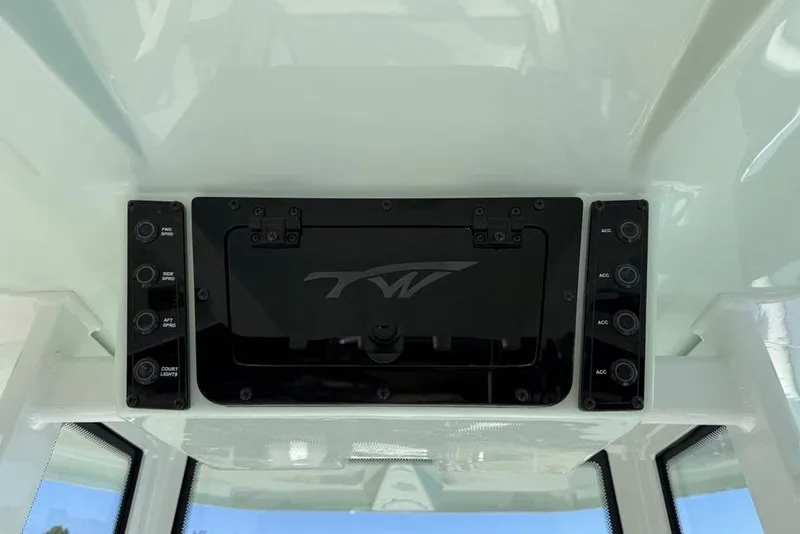 Slide: The Image of Control panel of 2026 Tidewater 2300 Carolina Bay boat with switches and logo. - 21