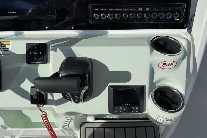 Slide: The Image of Control panel of 2026 Tidewater 2300 Carolina Bay boat with throttle and audio system. - 23