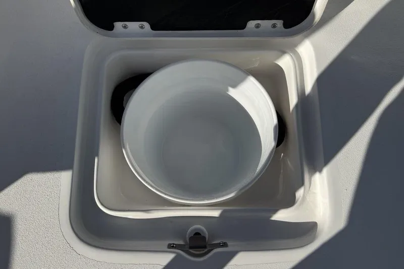 Slide: The Image of Storage compartment on 2026 Tidewater 2300 Carolina Bay boat, featuring a white container. - 26