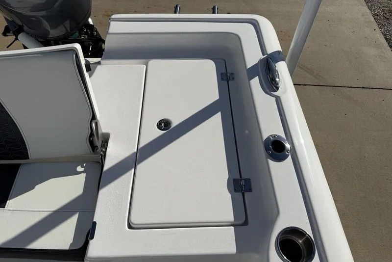 Slide: The Image of 2026 Tidewater 2300 Carolina Bay boat deck with storage compartment and cup holders. - 33