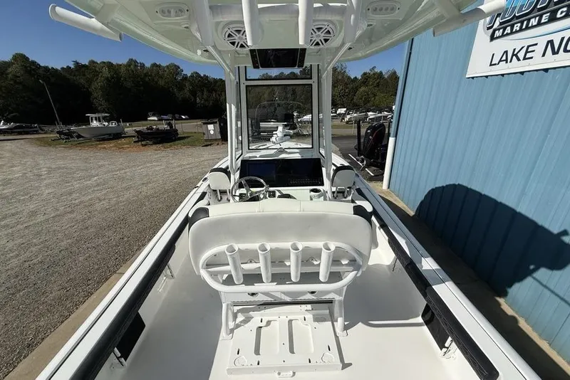 Slide: The Image of 2026 Tidewater 2300 Carolina Bay boat interior at a marina, featuring seating and steering console. - 35