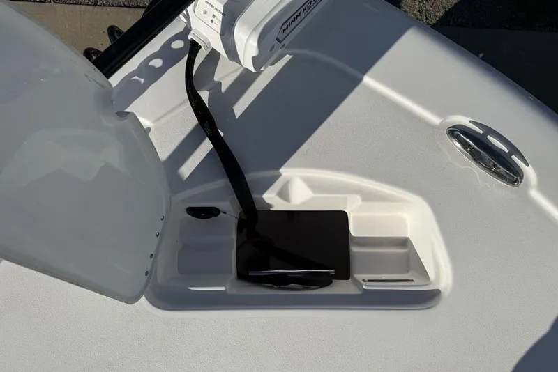 Slide: The Image of 2026 Tidewater 2300 Carolina Bay boat deck with storage compartment and Minn Kota trolling motor. - 8
