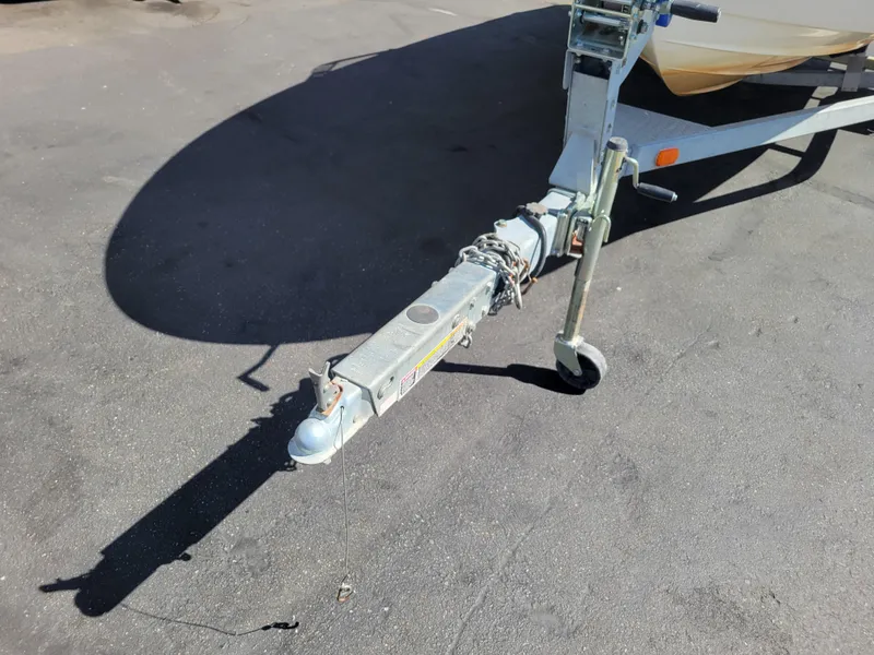 Slide: The Image of Trailer hitch of a 2006 Bayliner 195 boat on pavement. - 12