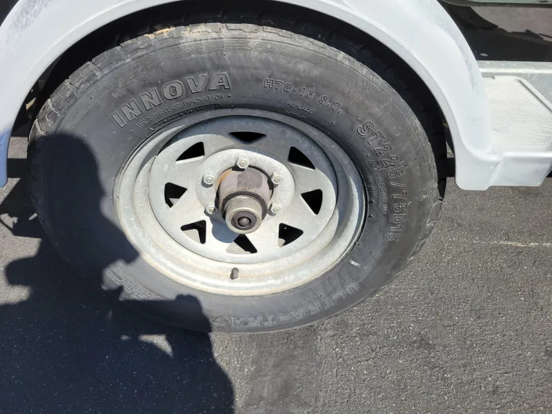 Slide: The Image of Trailer wheel of a 2006 Bayliner 195 boat, featuring Innova tire. - 13