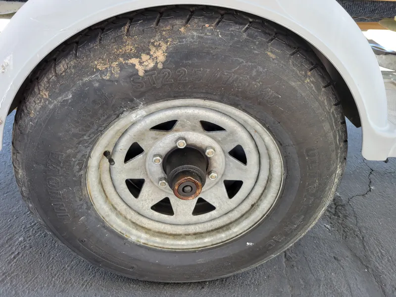 Slide: The Image of Close-up of a Bayliner 195 trailer tire, showing wear and dirt. - 14