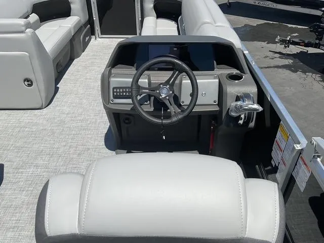 Slide: The Image of 2025 Sun Tracker Party Barge 20 DLX interior with steering console and seating. - 12