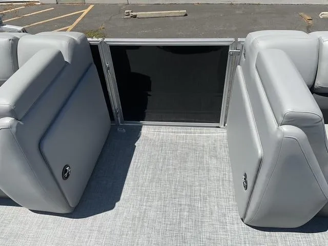 Slide: The Image of 2025 Sun Tracker Party Barge 20 DLX interior with gray seating and flooring. - 14