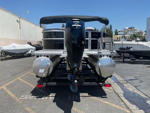 Slide: The Image of 2025 Sun Tracker Party Barge 20 DLX pontoon boat on trailer, rear view. - 3