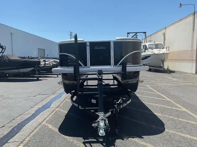 Slide: The Image of 2025 Sun Tracker Party Barge 20 DLX pontoon boat on trailer in parking lot. - 6