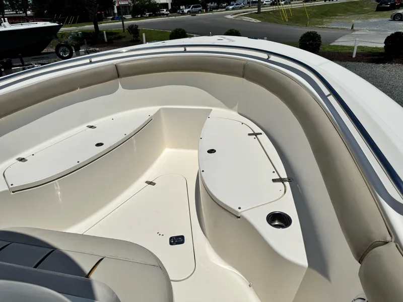 Slide: The Image of 2010 Pursuit C 280 Center Console boat interior with seating and storage compartments. - 11