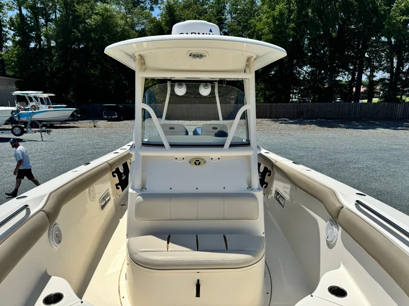Slide: The Image of 2010 Pursuit C 280 Center Console boat with seating, parked outdoors. - 12
