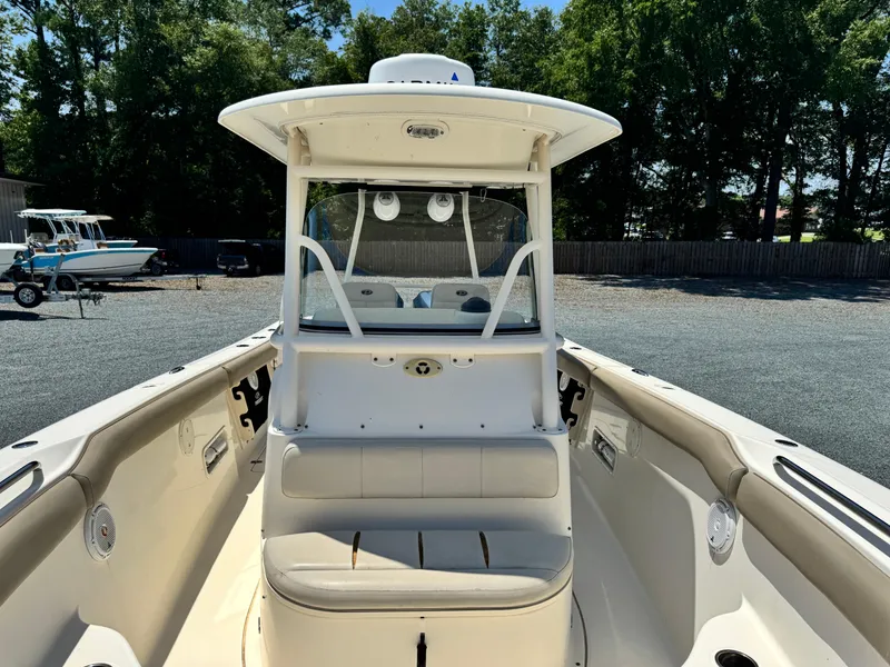 Slide: The Image of 2010 Pursuit C 280 Center Console boat with seating, parked outdoors. - 13