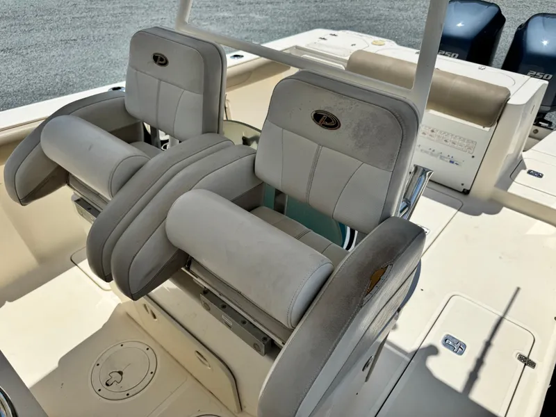 Slide: The Image of 2010 Pursuit C 280 Center Console boat seats with dual engines in the background. - 14