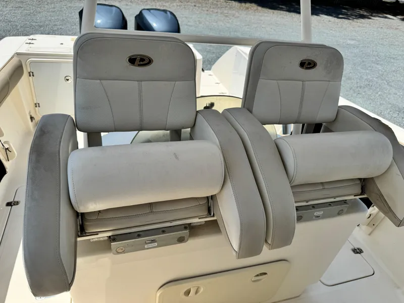 Slide: The Image of 2010 Pursuit C 280 Center Console boat seats with dual engines in background. - 15