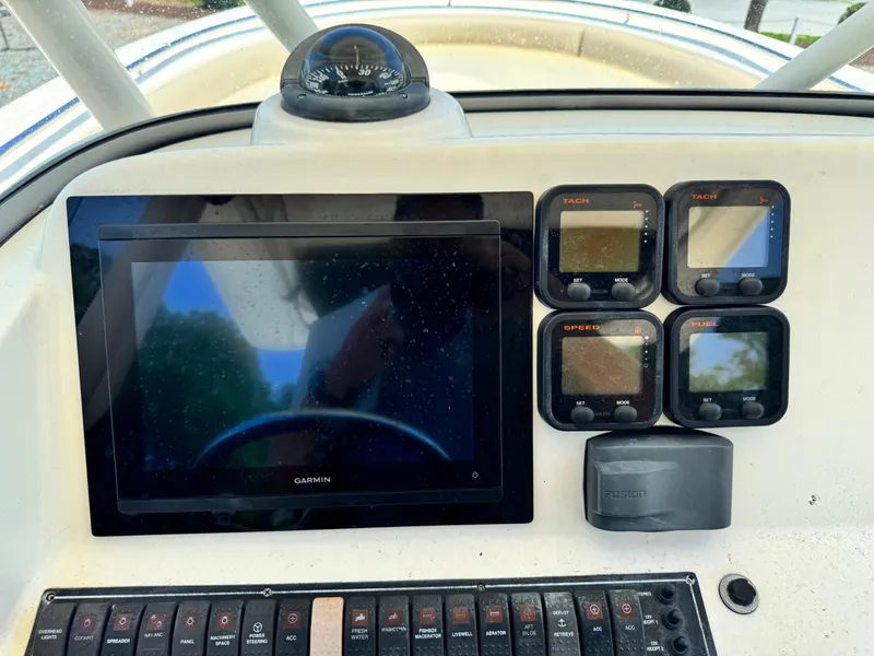 Slide: The Image of Dashboard of 2010 Pursuit C 280 Center Console with Garmin display and gauges. - 16