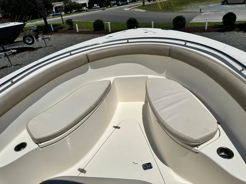 Slide: The Image of 2010 Pursuit C 280 Center Console boat interior with cushioned seating and cup holders. - 17