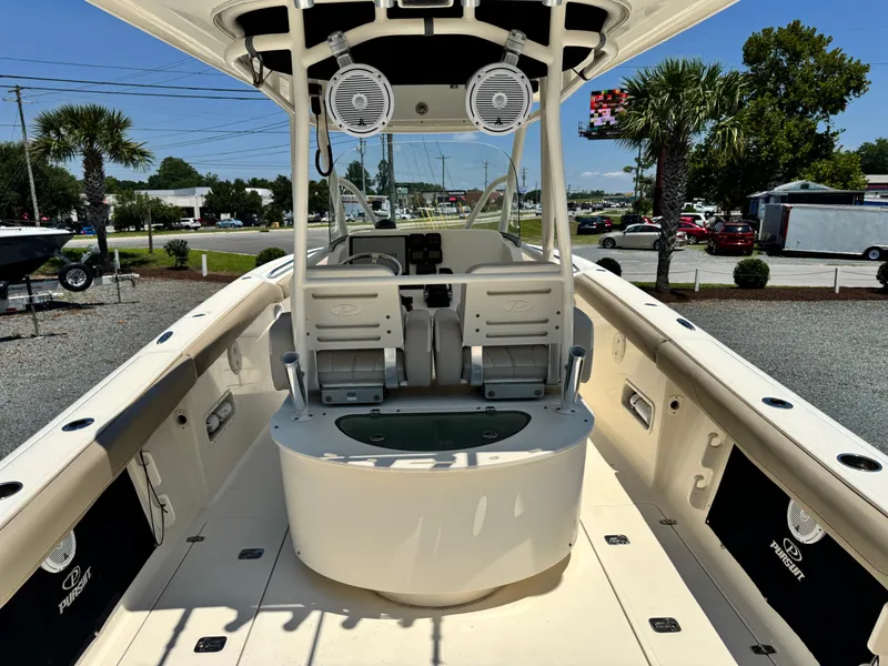 Slide: The Image of 2010 Pursuit C 280 Center Console boat interior with seating and speakers. - 21