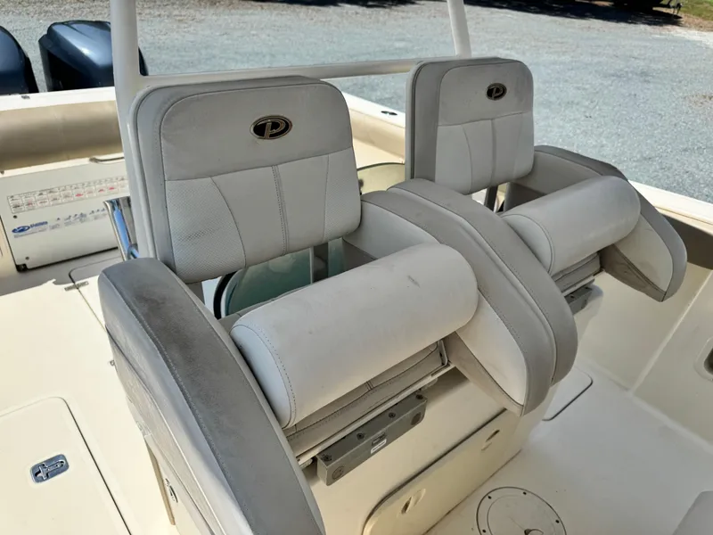 Slide: The Image of 2010 Pursuit C 280 Center Console boat seats, featuring dual cushioned chairs. - 23