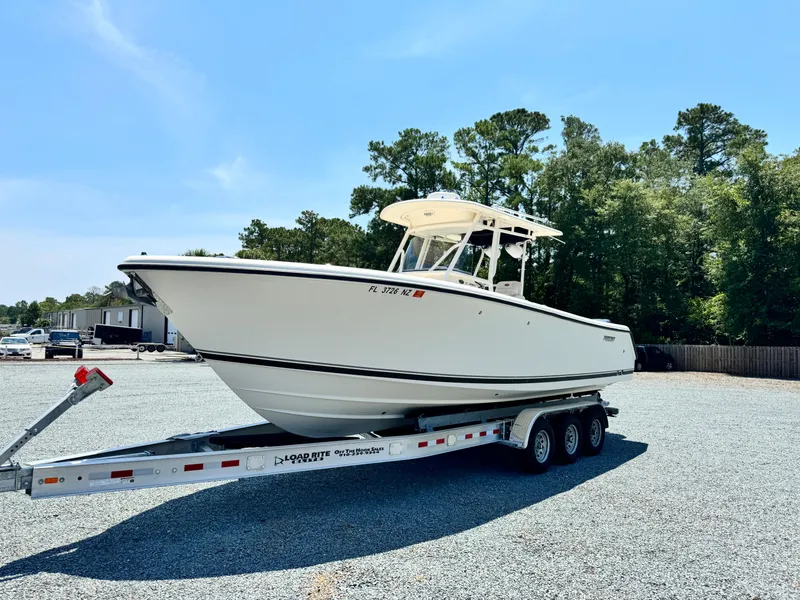 Slide: The Image of 2010 Pursuit C 280 Center Console boat on trailer in outdoor setting. - 6