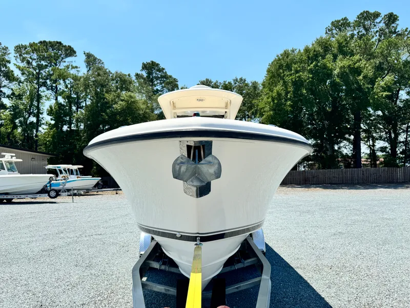 Slide: The Image of 2010 Pursuit C 280 Center Console boat on trailer, surrounded by trees and clear sky. - 7
