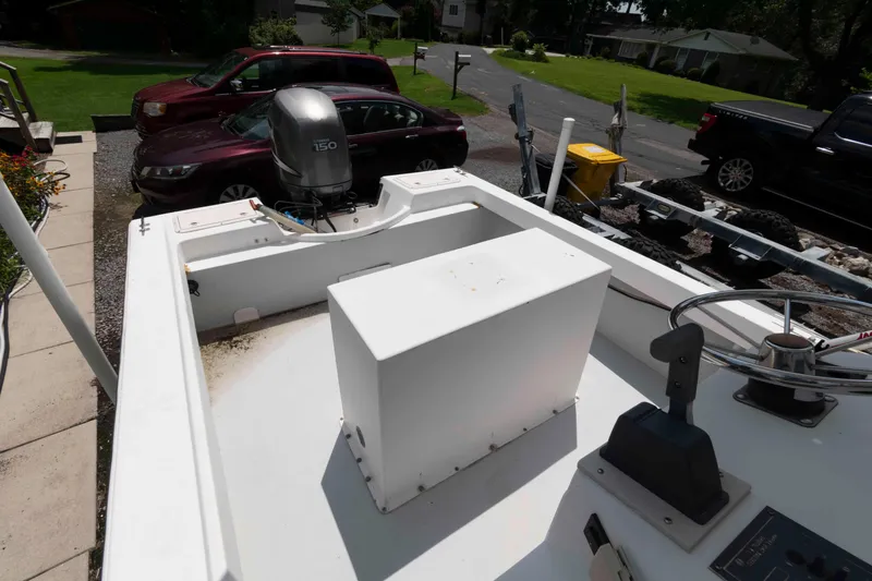 Slide: The Image of 1999 Custom High Seas Pumpout Boat with outboard motor, parked in a residential driveway. - 7