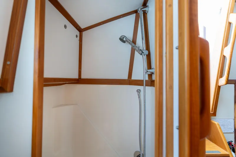 Slide: The Image of 1978 Cascade High Side boat interior shower with wooden trim and handheld showerhead. - 17