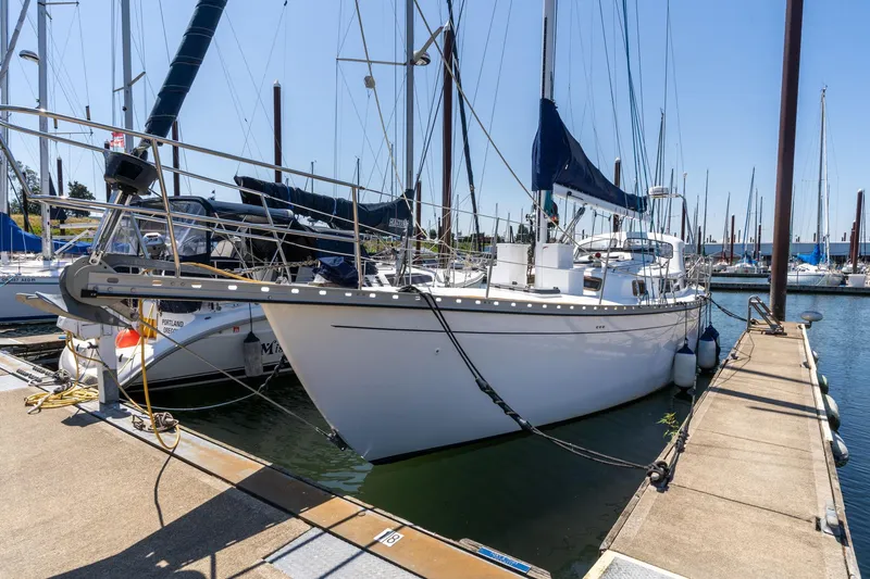 Slide: The Image of 1978 Cascade High Side sailboat docked at marina under clear blue sky. - 2