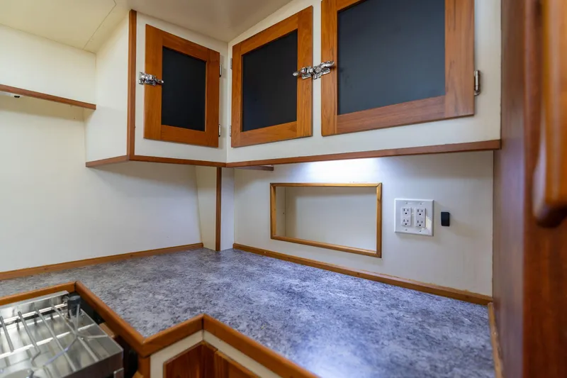 Slide: The Image of 1978 Cascade High Side kitchen with wooden cabinets and gray countertop. - 23