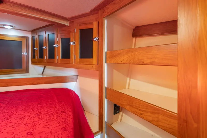 Slide: The Image of 1978 Cascade High Side interior with wooden cabinets and red bedding. - 28