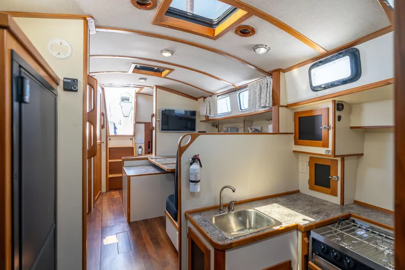 Slide: The Image of Interior of a 1978 Cascade High Side boat with modern kitchen and wood accents. - 29