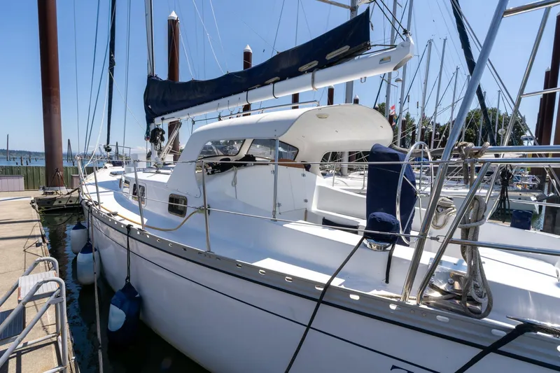 Slide: The Image of 1978 Cascade Hign Side sailboat docked at marina under clear blue sky. - 3