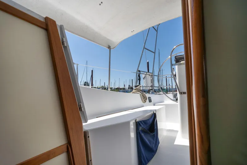 Slide: The Image of 1978 Cascade High Side sailboat cockpit with wooden trim and marina view. - 32