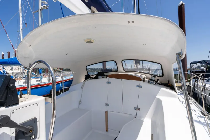 Slide: The Image of 1978 Cascade High Side sailboat cockpit with steering wheel and navigation equipment. - 34