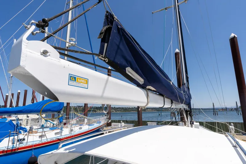 Slide: The Image of 1978 Cascade High Side sailboat with blue sail cover docked at marina. - 41