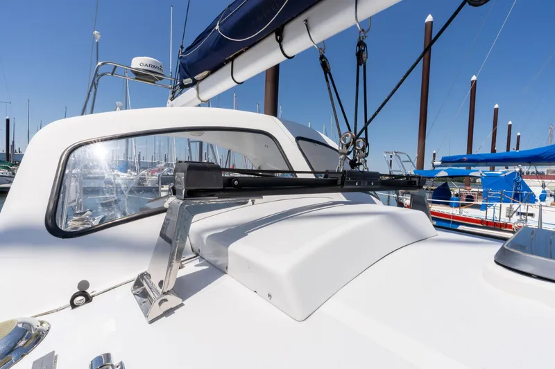 Slide: The Image of 1978 Cascade High Side sailboat deck with rigging and marina background. - 44