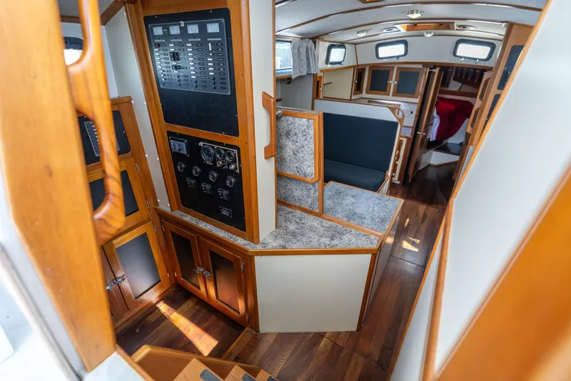 Slide: The Image of Interior of a 1978 Cascade High Side boat with wood paneling and control panels. - 6