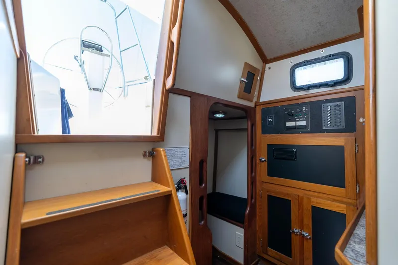 Slide: The Image of Interior of a 1978 Cascade High Side boat with wooden cabinetry and control panel. - 7