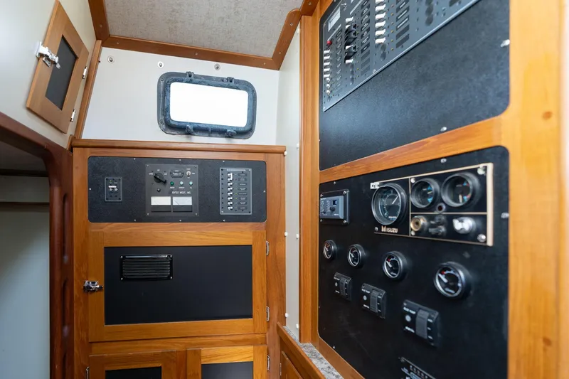 Slide: The Image of 1978 Cascade High Side boat control panel with gauges and switches in wooden interior. - 8