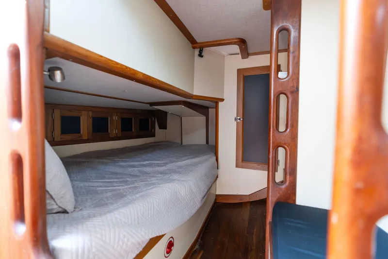 Slide: The Image of 1978 Cascade High Side boat interior with wooden bunk bed and cozy cabin design. - 9