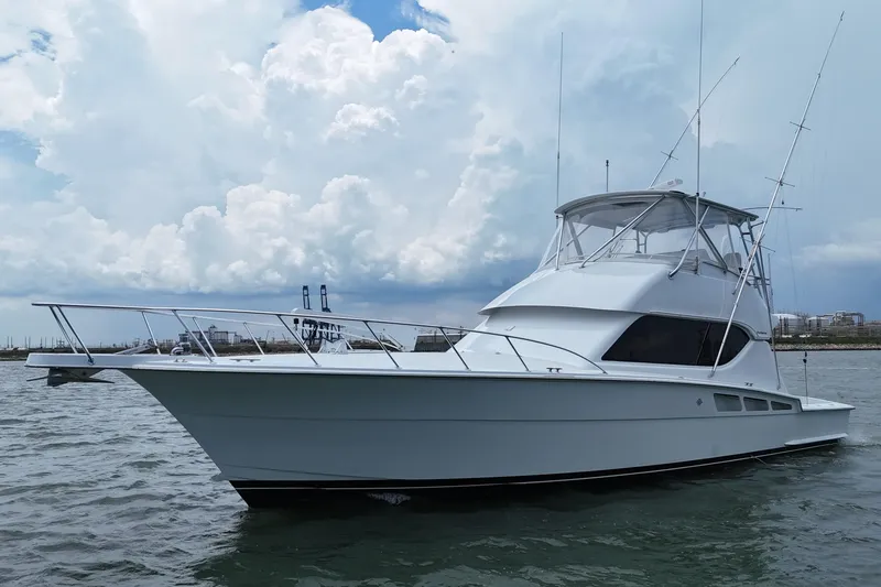 Slide: The Image of 2002 Hatteras 50 Convertible Sportfish yacht on water under cloudy sky. - 10