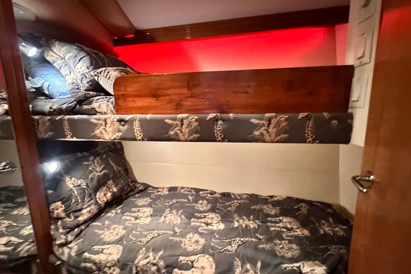 Slide: The Image of Bunk beds with animal print bedding in 2002 Hatteras 50 Convertible Sportfish cabin. - 100
