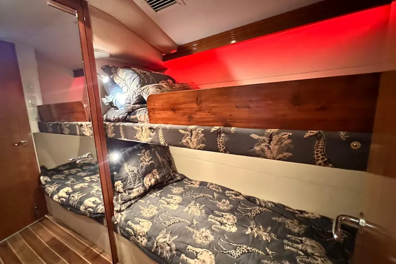 Slide: The Image of Interior of 2002 Hatteras 50 Convertible Sportfish with bunk beds and animal-themed bedding. - 101