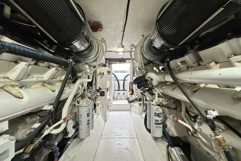 Slide: The Image of Engine room of 2002 Hatteras 50 Convertible Sportfish, showcasing dual engines and mechanical components. - 108