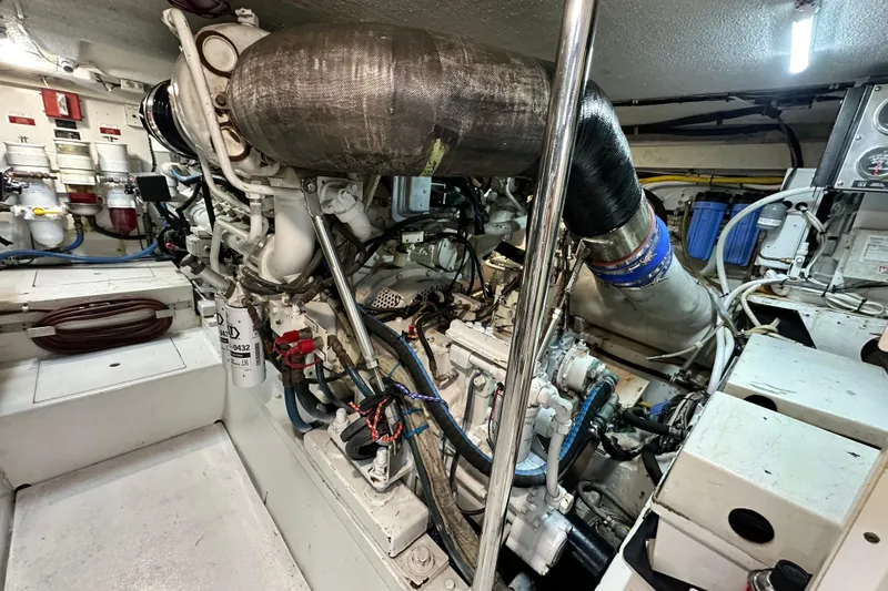 Slide: The Image of Engine room of 2002 Hatteras 50 Convertible Sportfish, showcasing complex machinery and components. - 109