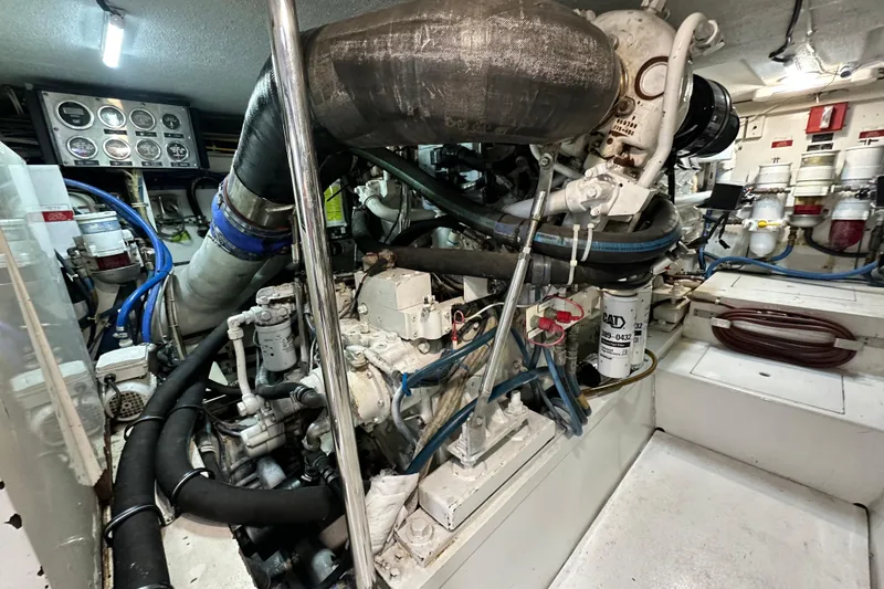 Slide: The Image of Engine room of 2002 Hatteras 50 Convertible Sportfish, showcasing complex machinery and components. - 111