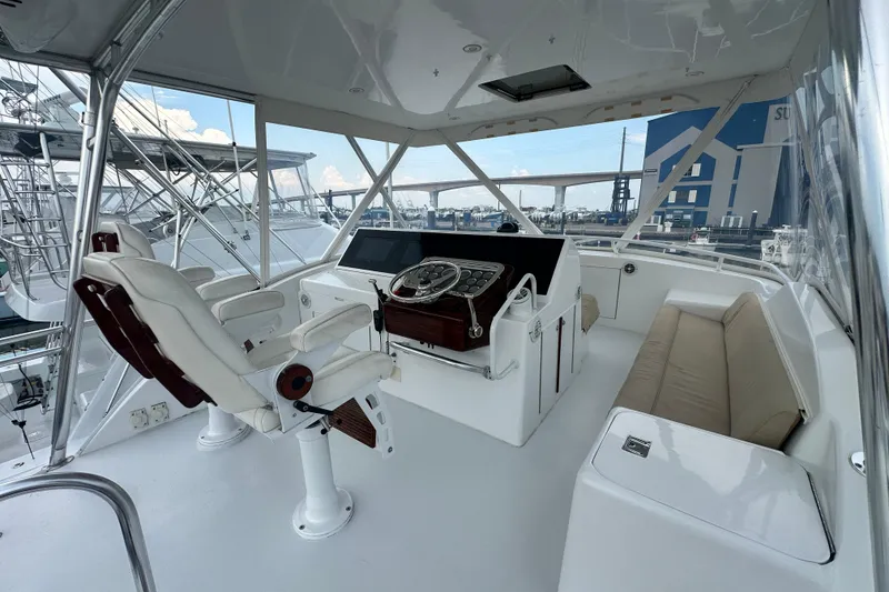 Slide: The Image of 2002 Hatteras 50 Convertible Sportfish helm with luxurious seating and modern controls. - 21