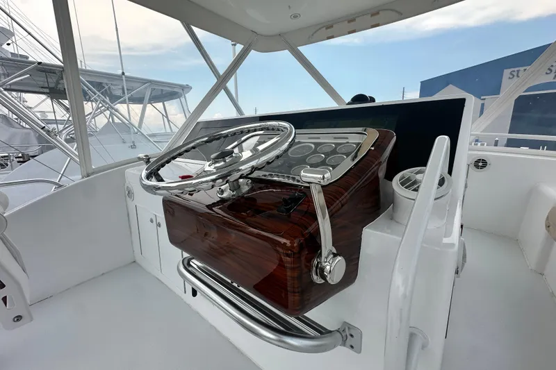 Slide: The Image of Helm of 2002 Hatteras 50 Convertible Sportfish with polished wood and chrome details. - 27