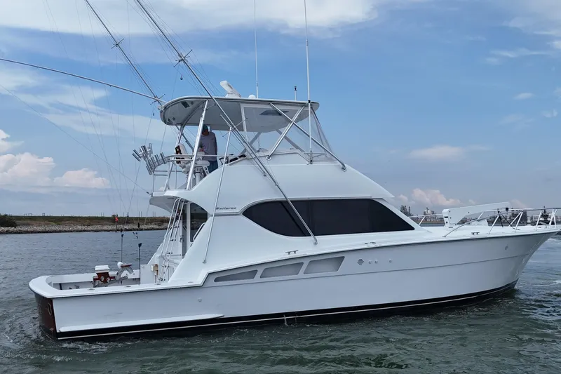 Slide: The Image of 2002 Hatteras 50 Convertible Sportfish yacht cruising on open water. - 3