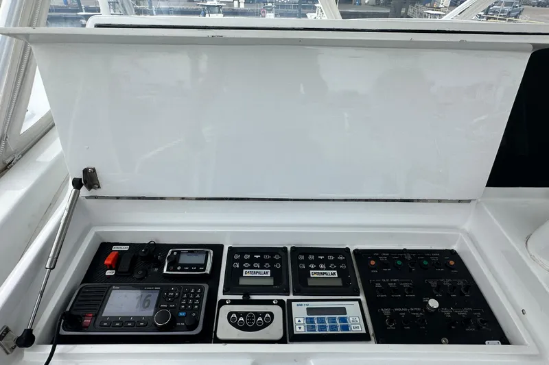 Slide: The Image of Control panel of a 2002 Hatteras 50 Convertible Sportfish boat with navigation equipment. - 31
