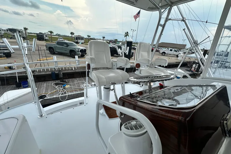 Slide: The Image of 2002 Hatteras 50 Convertible Sportfish yacht interior with captain's chairs and control panel. - 35